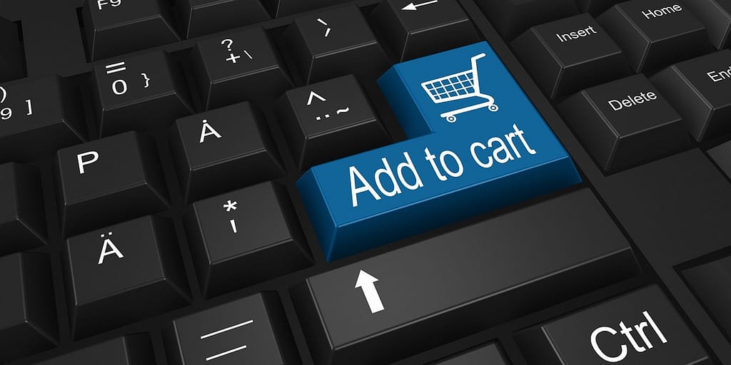 Teclado de computador com a frase add to cart, adicionar ao carrinho, em referência às compras online. 